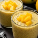 Delicious creamy mango chia pudding topped with fresh mango and coconut flakes.