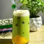 Refreshing Iced Mango Matcha Latte with mango purée and matcha powder served over ice.