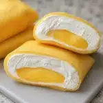Hong Kong style mango pancakes decorated with whipped cream and fresh mango slices