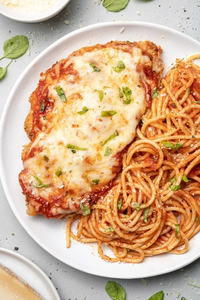 Crispy and cheesy Baked Chicken Parmesan served with marinara sauce