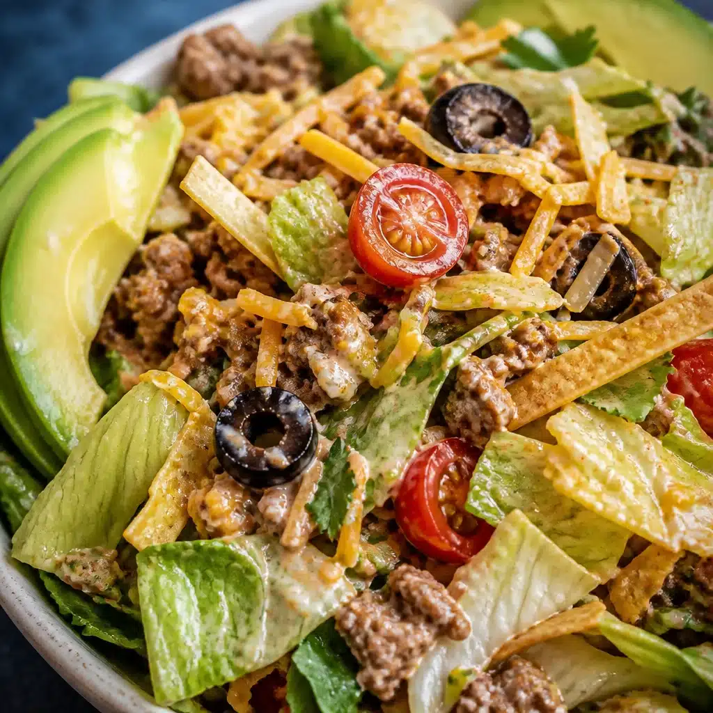 Low carb taco salad with ground beef, lettuce, cheese, and avocado dressing