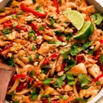 Delicious Chicken Pad Thai featuring rice noodles, fresh vegetables, and chicken in a savory sauce.
