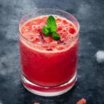 Refreshing homemade Watermelon Juice served in a glass with a slice of watermelon.