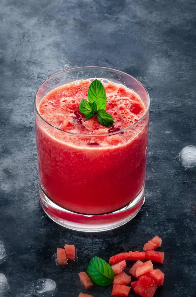 Refreshing homemade Watermelon Juice served in a glass with a slice of watermelon.