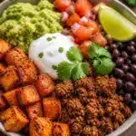 Colorful Sweet Potato Taco Bowl topped with fresh ingredients and avocado.