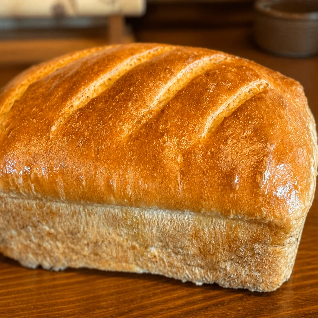 Homemade soft sourdough sandwich bread loaf, perfect for making delicious sandwiches.