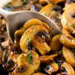Sautéed mushrooms with garlic and herbs in a skillet.