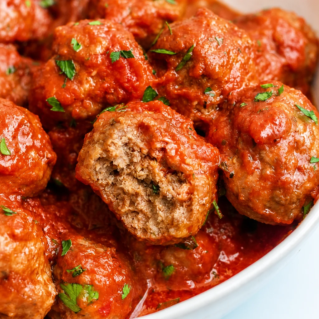 Delicious Best Oven Baked Italian Meatballs served with marinara sauce.