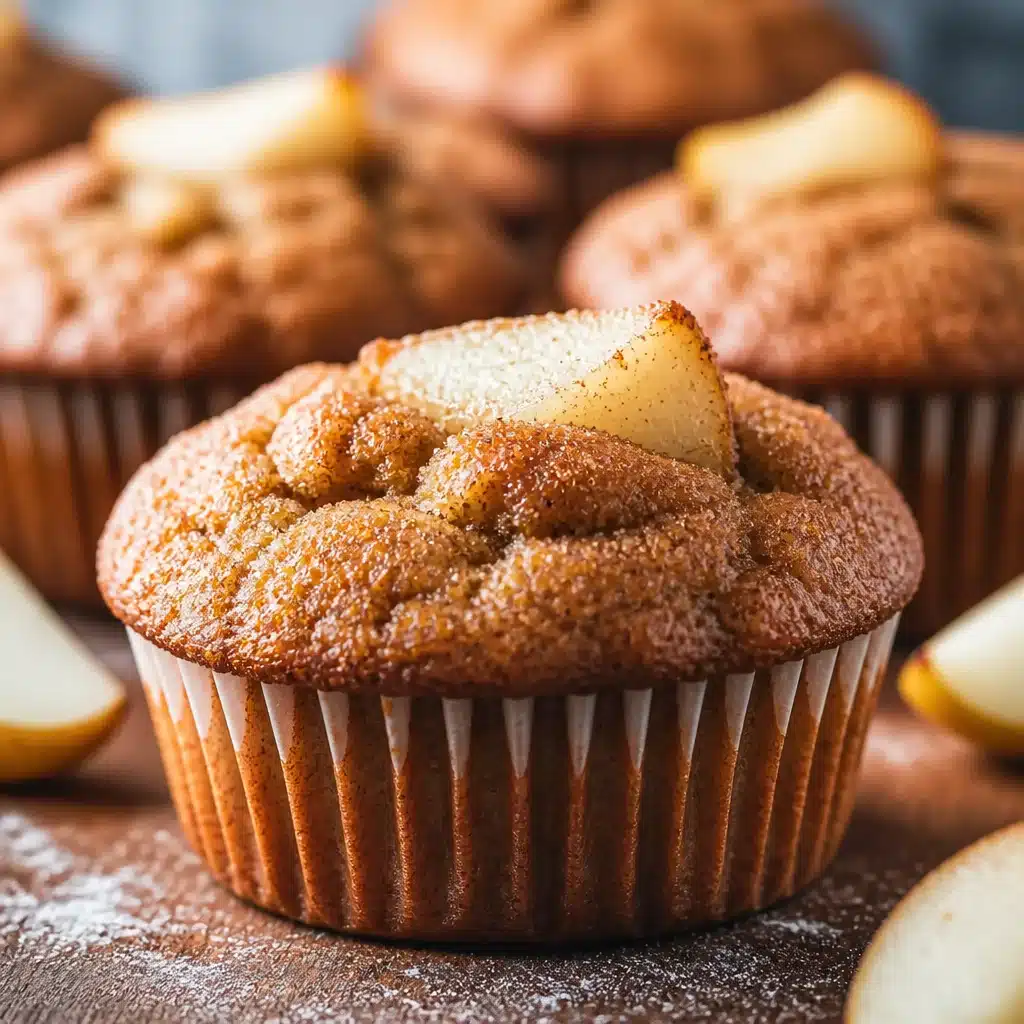 Delicious spiced pear muffins topped with cinnamon sugar and fresh pear chunks