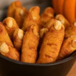 Spooky Witches’ Fingers Cookies shaped like fingers with almond nails and jam.