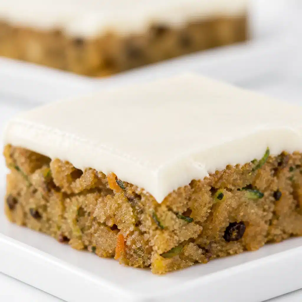 Delicious zucchini bars topped with cream cheese frosting, perfect for dessert.