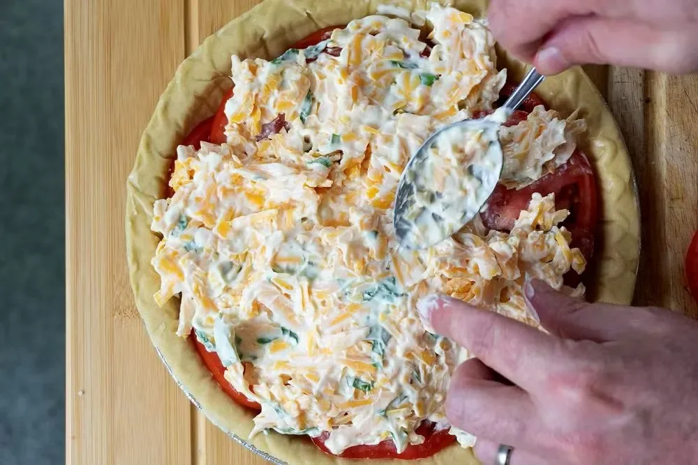 Delicious Southern Tomato Pie with fresh tomatoes, cheese, and herbs in a flaky crust.
