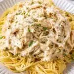 Crock Pot Angel Chicken served over angel hair pasta with creamy sauce