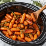 Bowl of slow cooker maple glazed carrots topped with a rich glaze of maple syrup and brown sugar.