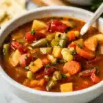 Bowl of healthy vegetable soup packed with fresh ingredients and vibrant colors
