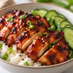 Delicious Honey Gochujang Chicken garnished with fresh herbs and spices.